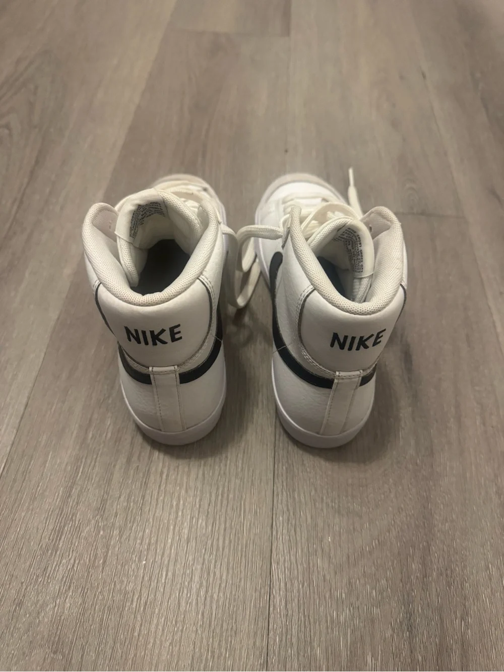 Nike Women's White High-Top Sneakers with Black Swoosh